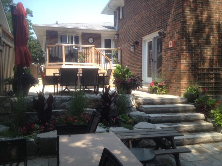 Stone steps and planting leading up to a raised deck