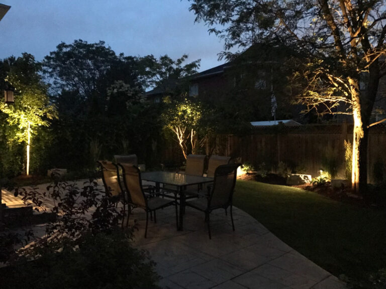 A patio and garden lit at dusk
