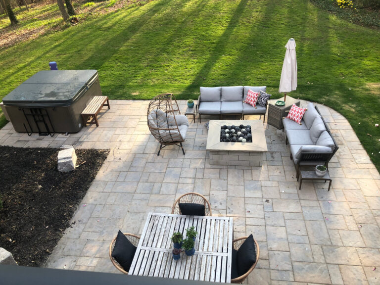 A patio with a fire table and outdoor sofas