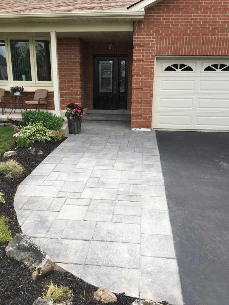 A wide paver walkway at the front door