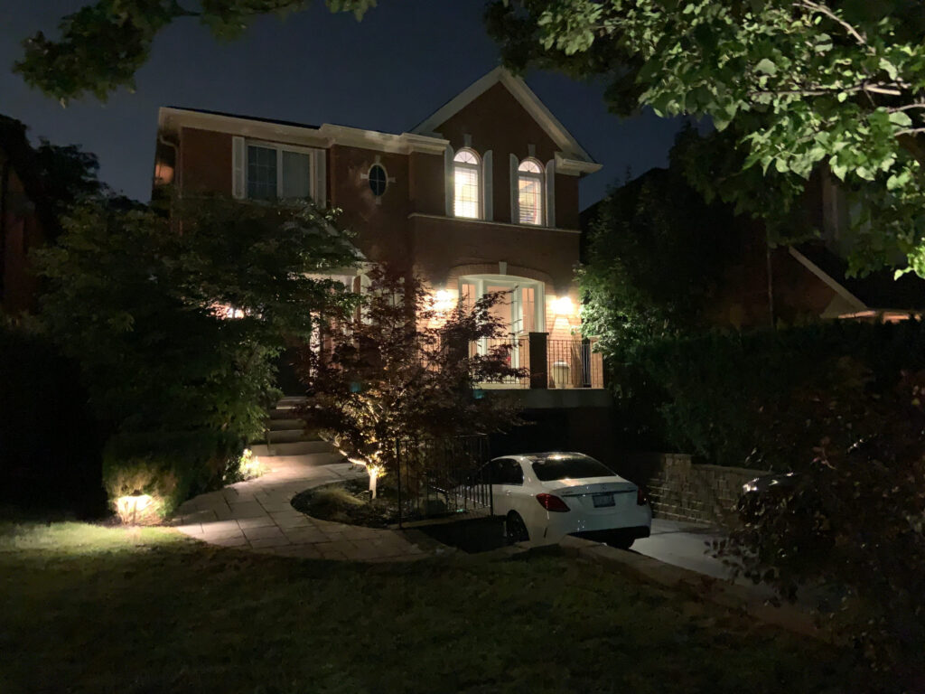 A house and front garden lit at night