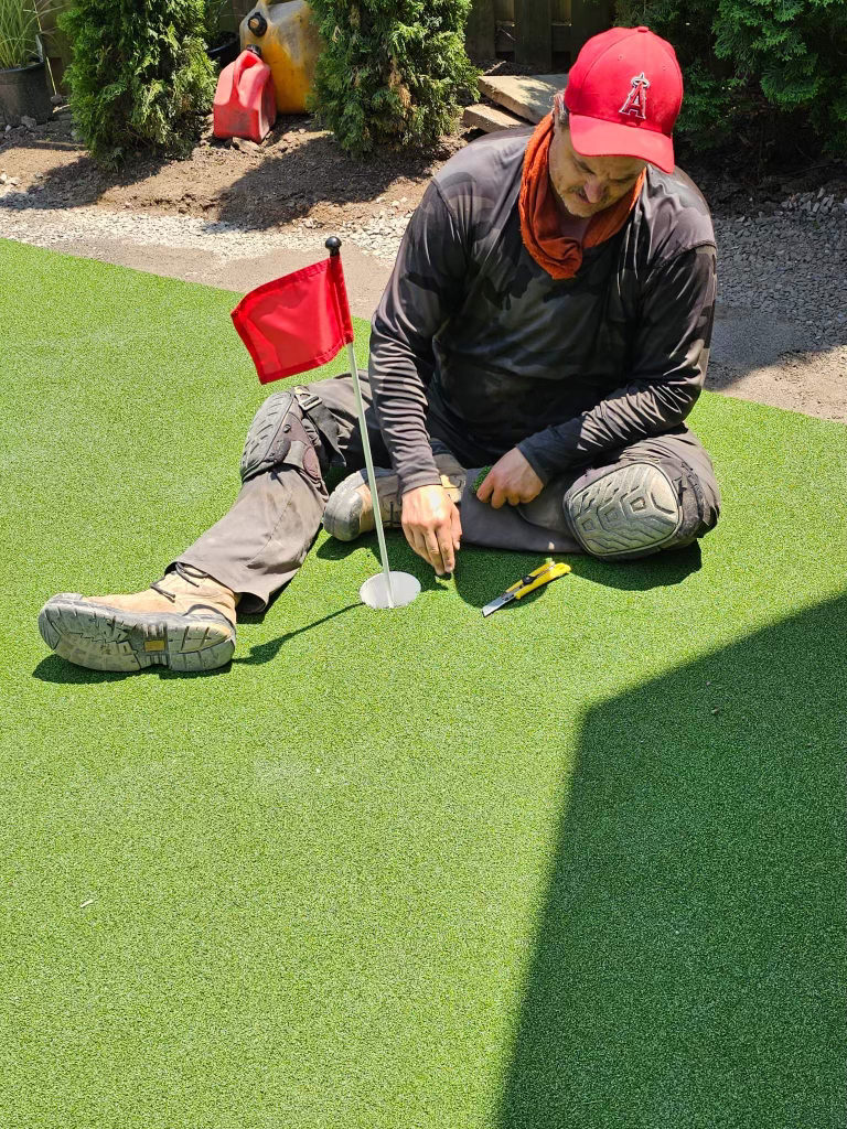 Mark setting the cup on a putting green