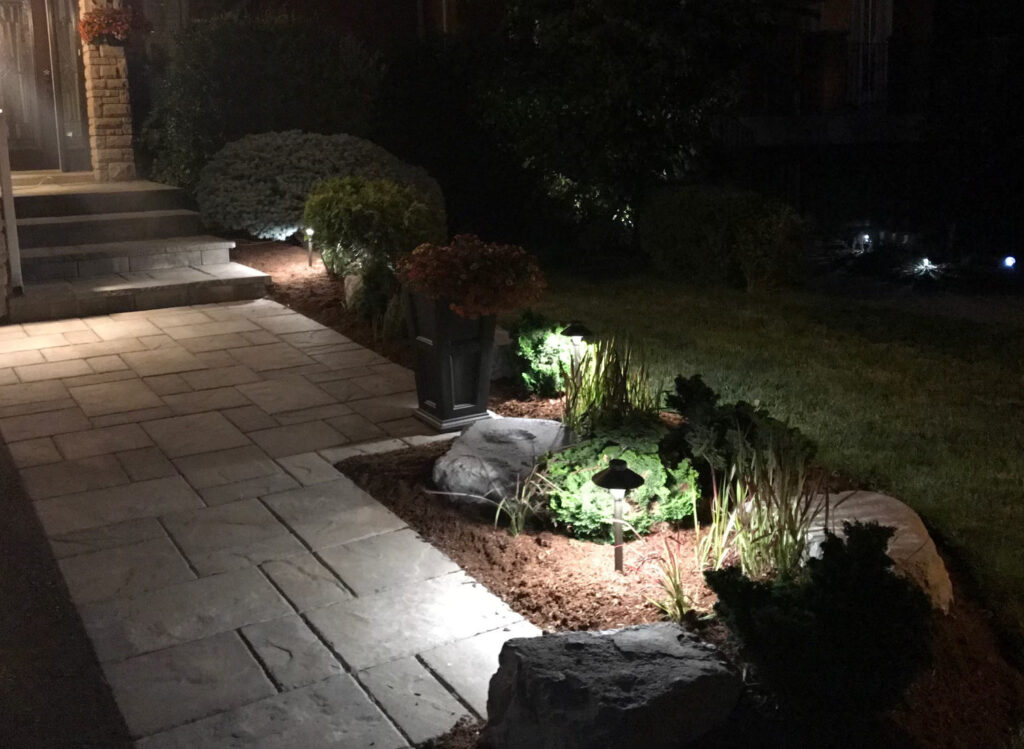 A stone walkway lit by low-voltage path lights