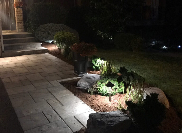 A stone walkway lit by low-voltage path lights