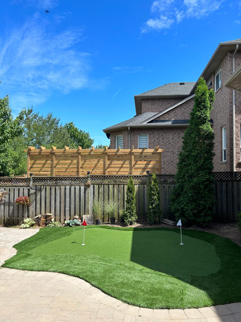 A putting green below a pergola
