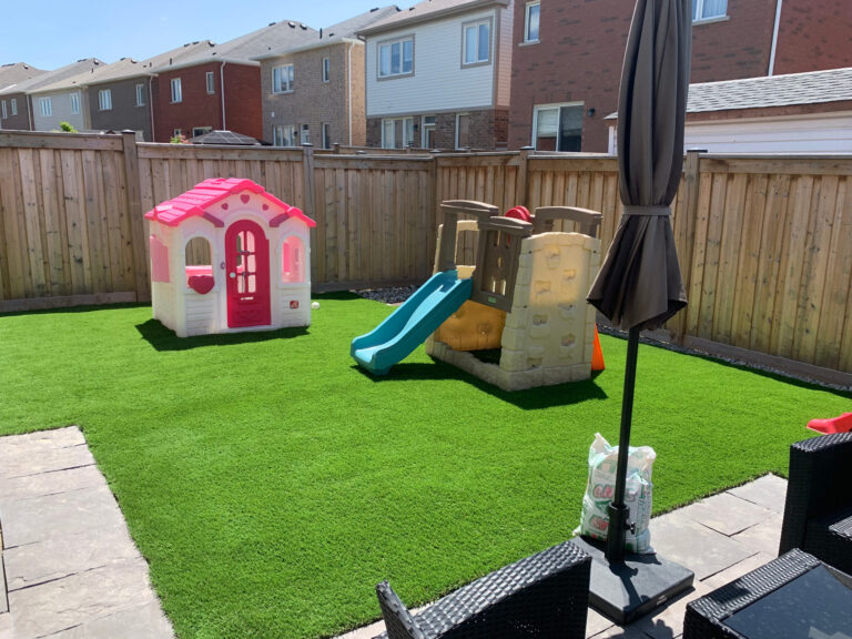 Artificial turf play area with a playhouse and slide