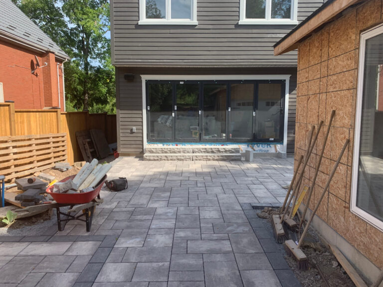 A large-format slab patio at the back of a house
